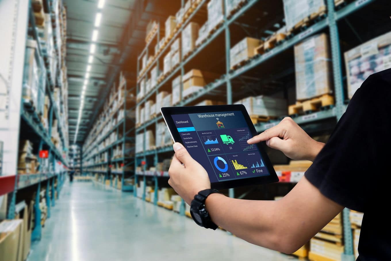 pracownik magazynu trzymający tablet z danymi magazynowymi